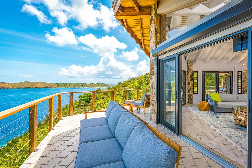 The wrap-around deck at Alize Villa looking out on a spectacular Leverick Bay, Virgin Gorda, on a bright, sunny day.