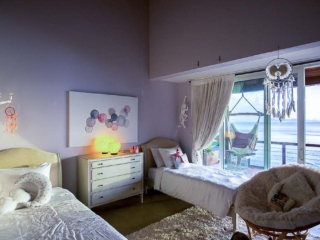 La Vida Villa: Double Bedroom La Vida Villa guest room with twin beds, a chest of drawers and basket chair with a window to a patio looking out on the sea.