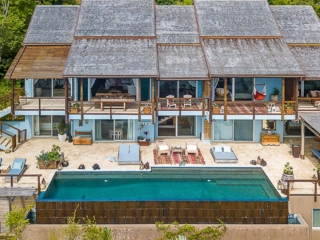 La Vida Villa: Facade La Vida Villa’s two-level façade with multiple elevated balconies looking out on a large stone sundeck and pool.