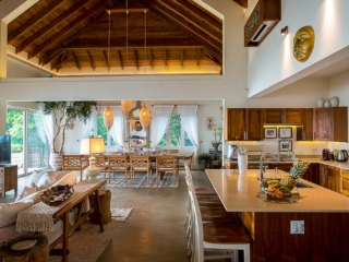 La Vida Villa: Kitchen La Vida Villa’s airy great room with lofted ceilings, stone floors and separate kitchen, dining and living areas.