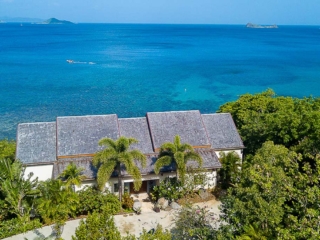 La Vida Villa: Waterfront View La Vida Villa front façade and waterfront looking out on the crystal blue Caribbean Sea in the background.