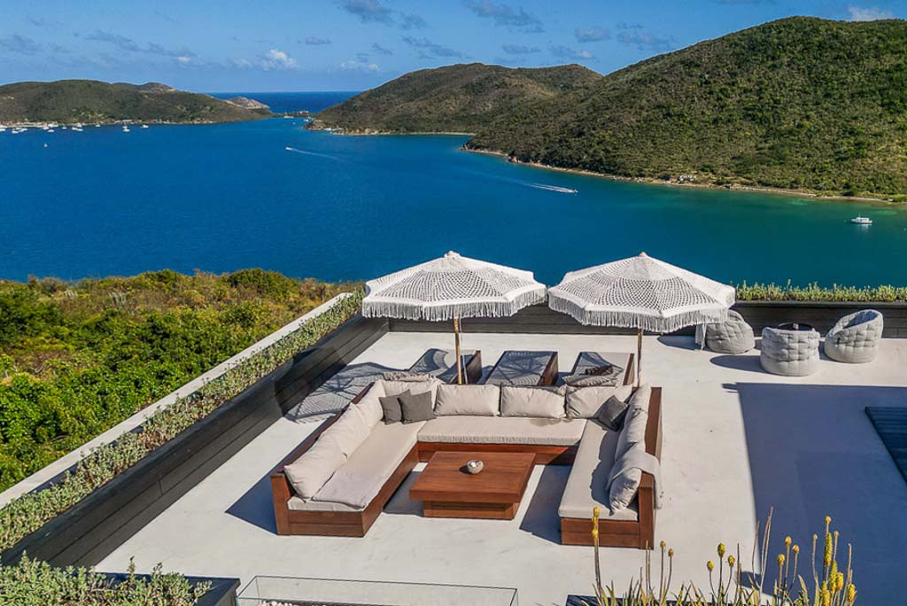 Segura Villa’s lounging and entertaining area of it’s rooftop deck with beautiful Leverick Bay and hills in the background.